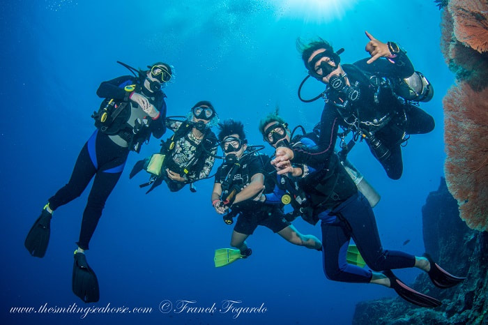 Happy divers in the blue