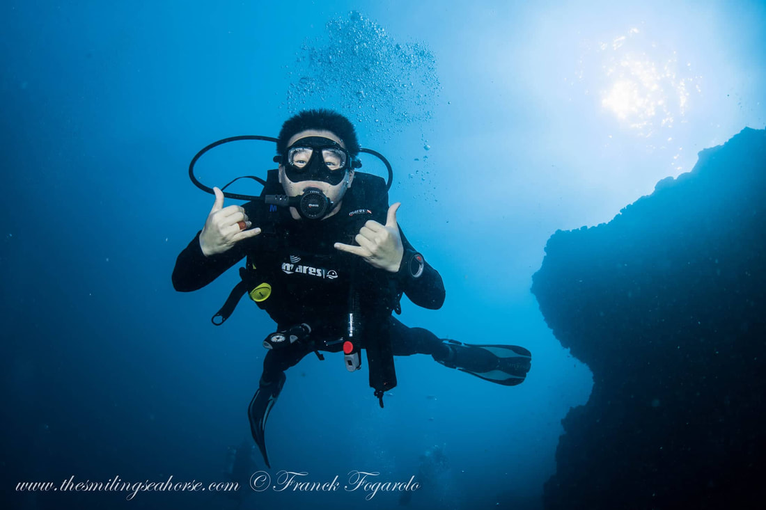 Streamlined divers exploring the underwater world in the Andaman Sea